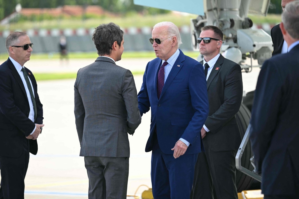 US President Joe Biden (C) is welcomed by France's Prime Minister Gabriel Attal upon arrival at Paris Orly airport near Paris. — AFP