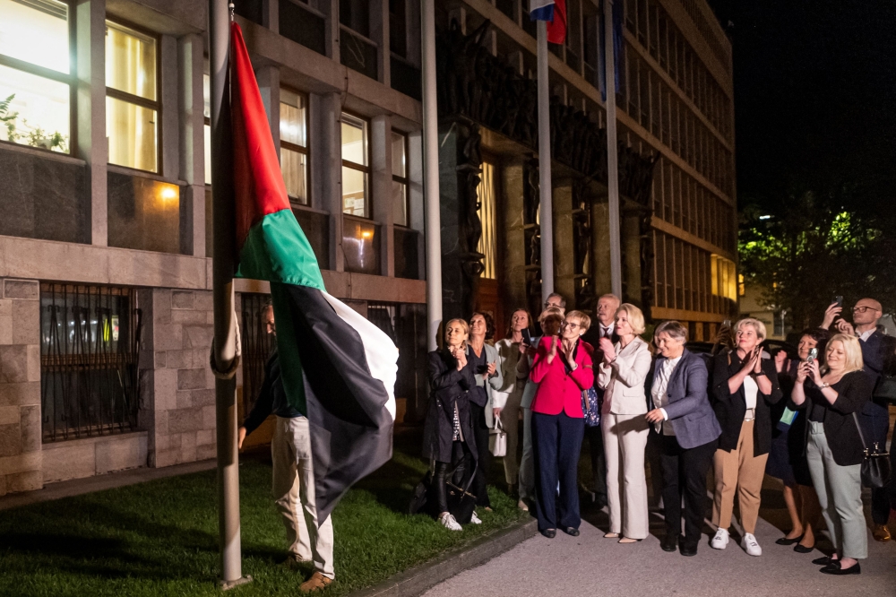 People hang a Palestinian flag in front of the Parliament building recognising the Palestinian state in Ljubljana, Slovenia. — AFP 