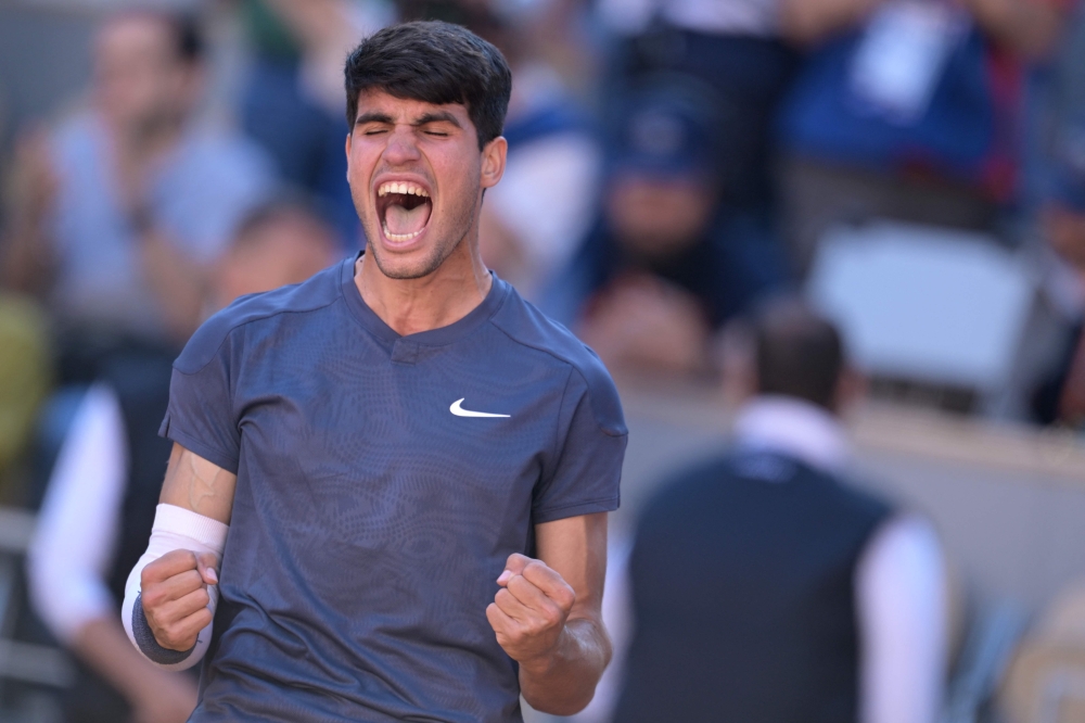 Spain's Carlos Alcaraz celebrates after winning his men's singles semi final match against Italy's Jannik Sinner 