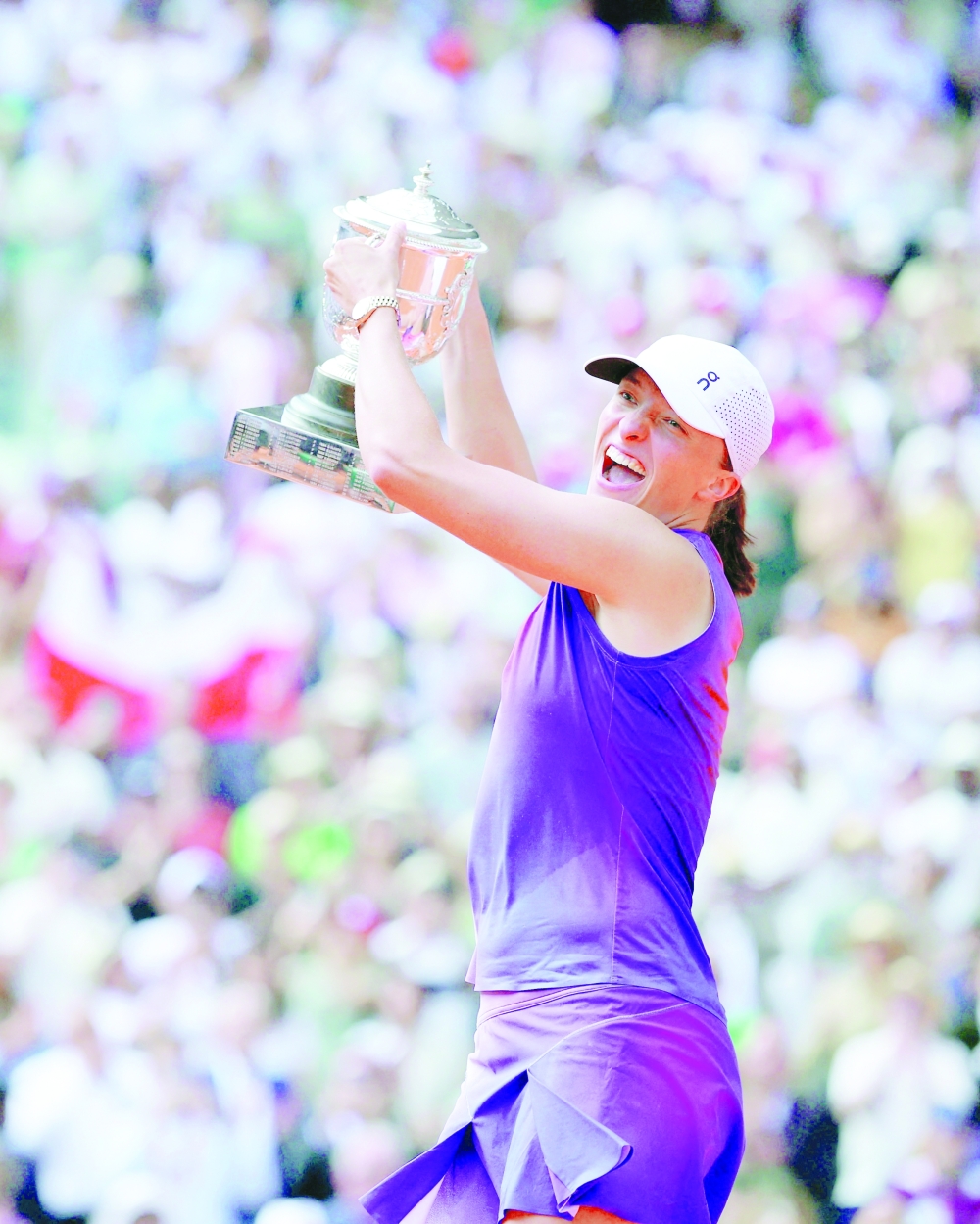 Poland's Iga Swiatek celebrates with the trophy after winning her final match against Italy's Jasmine Paolini