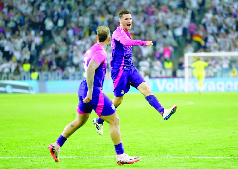 Pascal Gross celebrates scoring their second goal with David Raum.— REUTERS