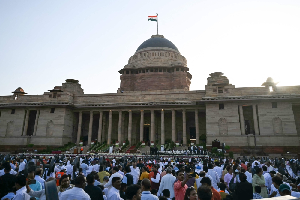 People gather ahead of the oath-taking ceremony of India's prime minister and council of ministers at the presidential palace Rashtrapati Bhavan in New Delhi. — AFP 