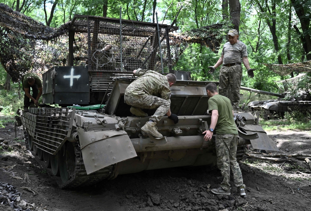 Ukrainian servicemen do maintenance on their T-72 tank at an undisclosed location in the Donetsk region. — AFP 