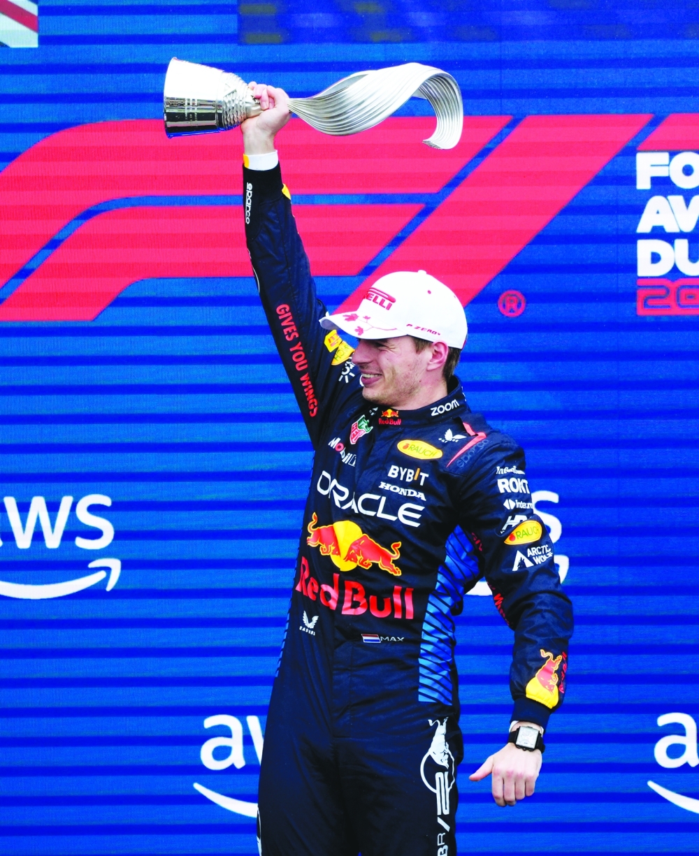 Formula One F1 - Canadian Grand Prix - Circuit Gilles Villeneuve, Montreal, Canada - June 9, 2024 Red Bull's Max Verstappen celebrates on the podium with a trophy after winning the Canadian Grand Prix REUTERS/Mathieu Belanger
