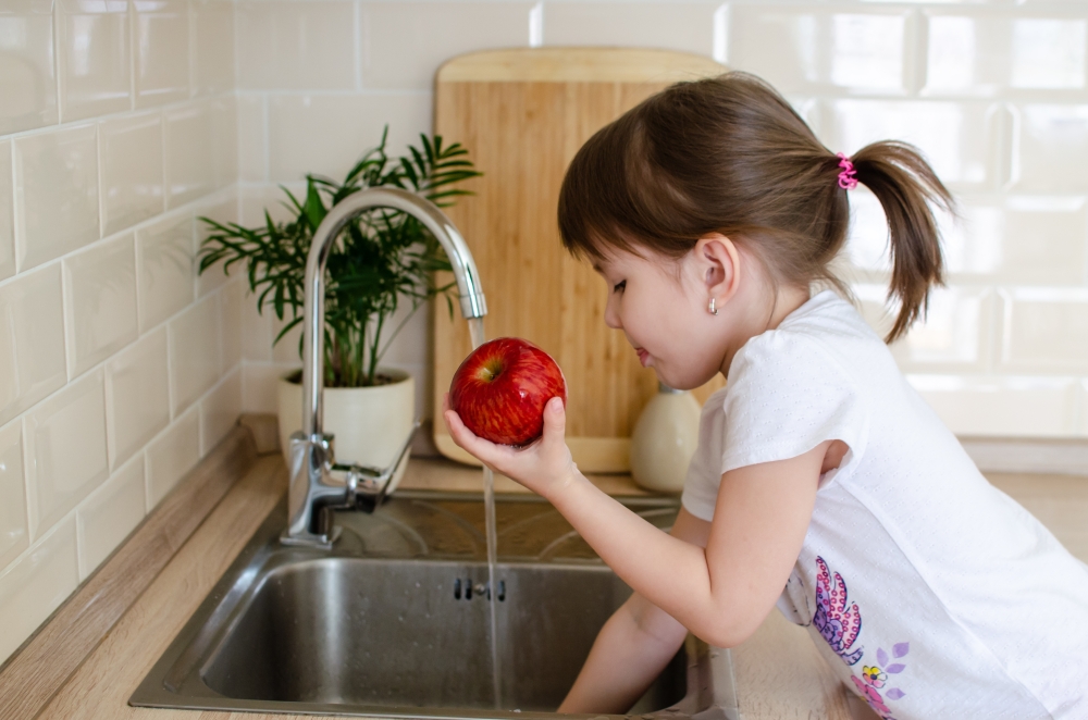 A,Cute,Little,Girl,Washes,A,Red,Apple,In,A