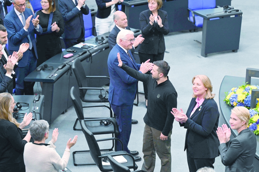 Ukrainian President Volodymyr Zelensky (3rdR) makes a greeting gesture as he receives an applause after giving a speech at the German Bundestag, in Berlin. — AFP 