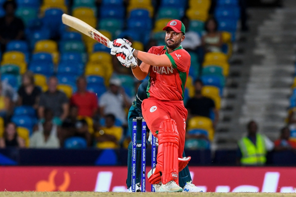 Ayaan Khan of Oman hits 6 during the ICC men's Twenty20 World Cup 2024 group B cricket match between Australia and Oman at Kensington Oval in Bridgetown, Barbados, on June 5, 2024.  (Photo by Randy Brooks / AFP)