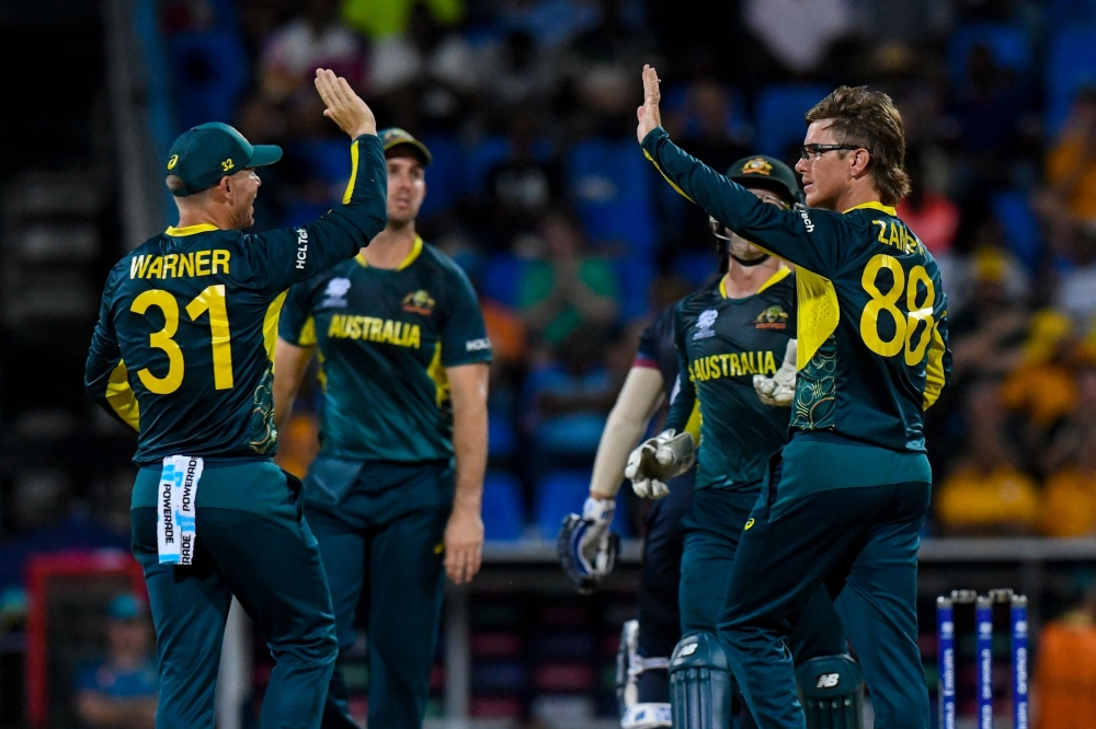 Australia's Adam Zampa (R) celebrates the dismissal of    Namibia's Zane Green during the ICC men's Twenty20 World Cup 2024 group B cricket match between Australia and Namibia at Sir Vivian Richards Stadium in North Sound, Antigua and Barbuda on June 11, 2024.  Adam Zampa (R) of Australia celebrates the dismissal of Zane Green of Namibia (Photo by Randy Brooks / AFP)

