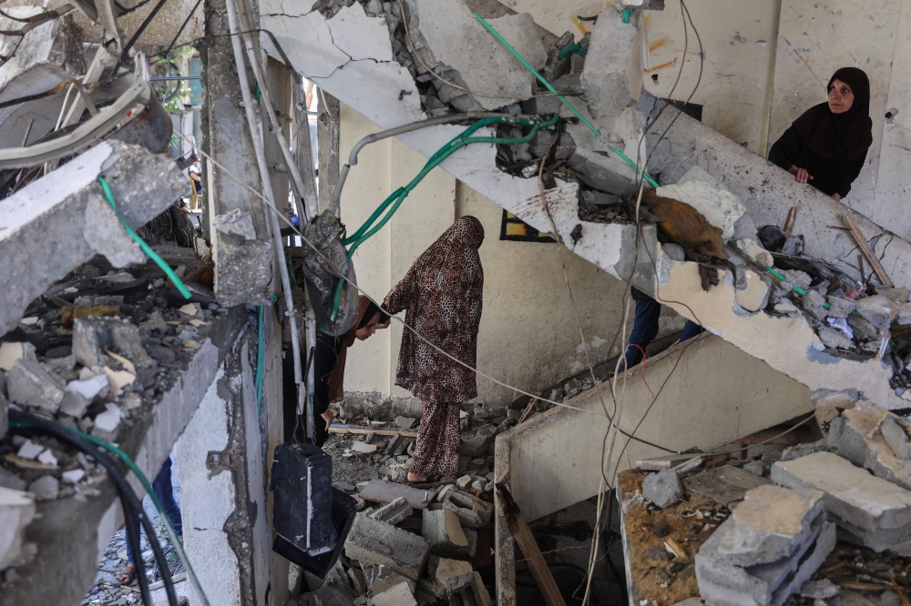 Palestinians inspect the damage in a house after an overnight Israeli strike on Al-Daraj neighbourhood in Gaza City on Wednesday. — Reuters 