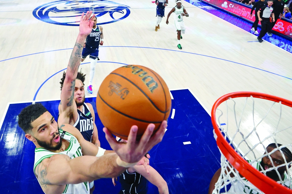 Boston Celtics forward Jayson Tatum (0) shoots the ball against Dallas Mavericks centre Dereck Lively II (2) during game three of the 2024 NBA Finals at American Airlines Center