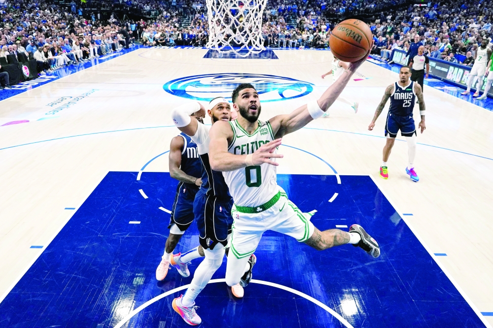 Boston Celtics forward Jayson Tatum (0) shoots the ball against Dallas Mavericks centre Dereck Lively II (2) during game three of the 2024 NBA Finals at American Airlines Center