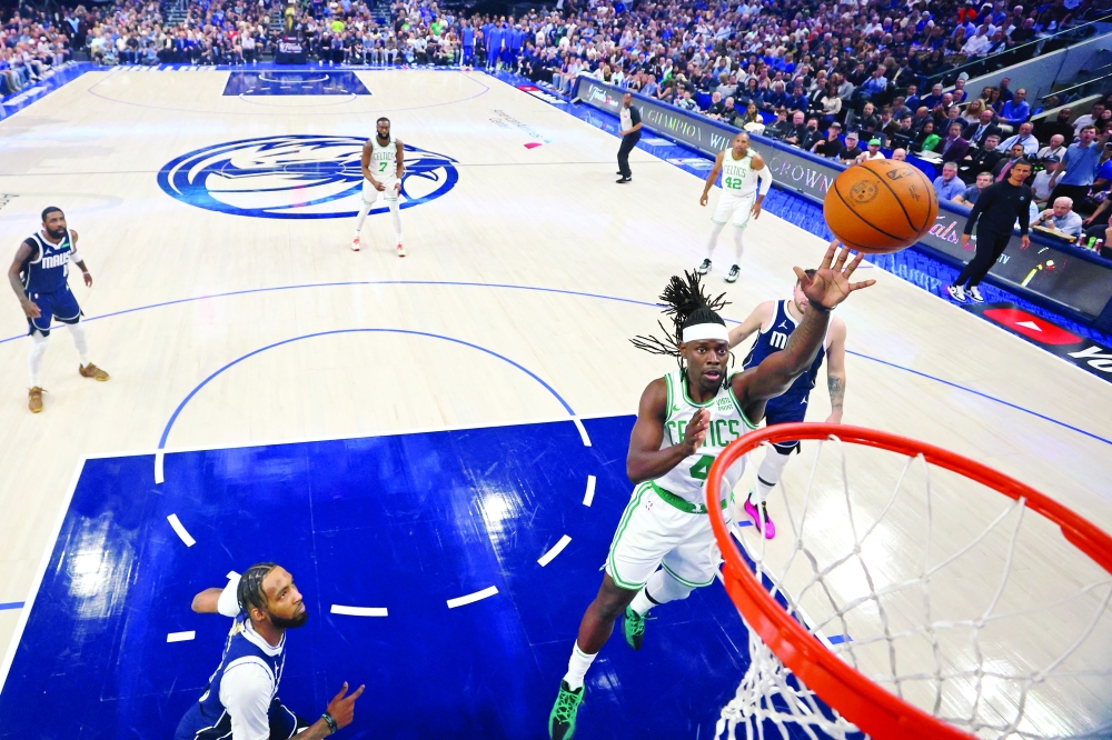 Boston Celtics forward Jayson Tatum (0) shoots the ball against Dallas Mavericks centre Dereck Lively II (2) during game three of the 2024 NBA Finals at American Airlines Center