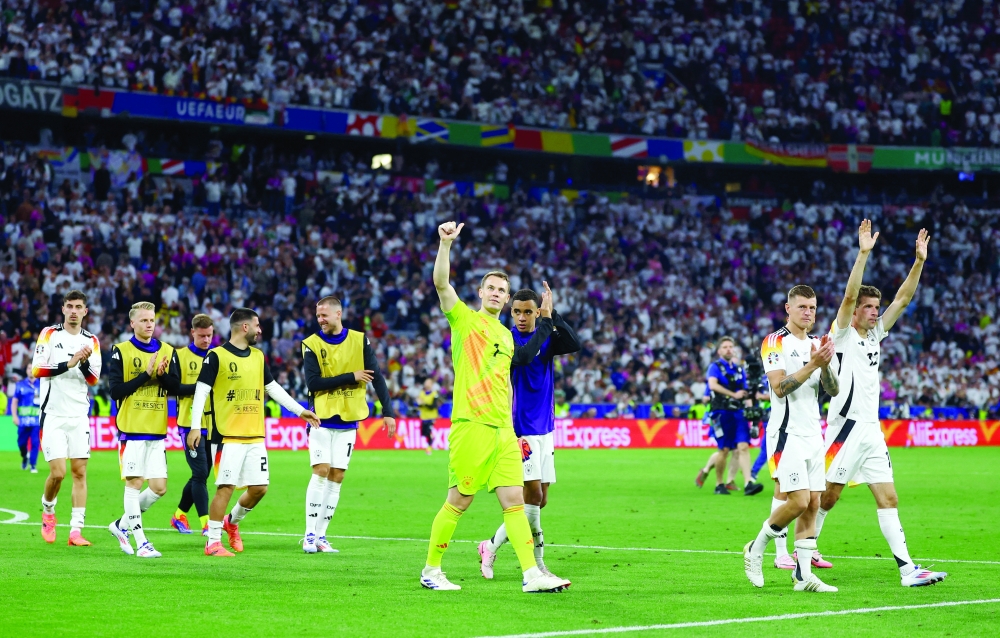 Germany's Manuel Neuer and Jamal Musiala celebrate after the match REUTERS