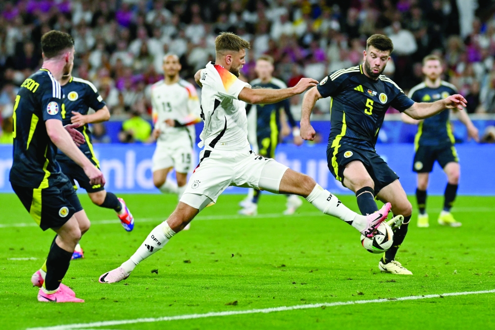 Niclas Fuellkrug (L) fights for the ball with Scotland's defender #05 Grant Hanley during the UEFA Euro 2024 -- AFP