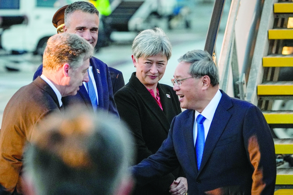 China's Premier Li Qiang (R) greets Australia's FM Penny Wong (C), South Australia's Premier Peter Malinauskas at Adelaide Airport. — Reuters 