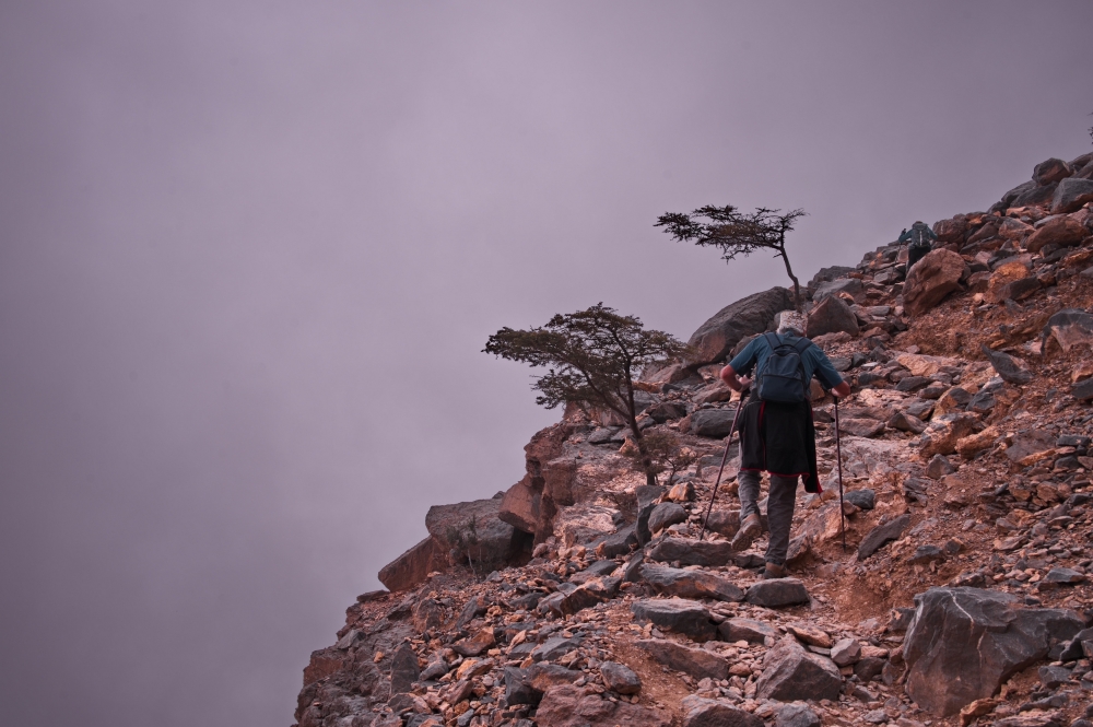 Senior,Man,Hiking,At,The,Edge,Of,Deep,Canyon