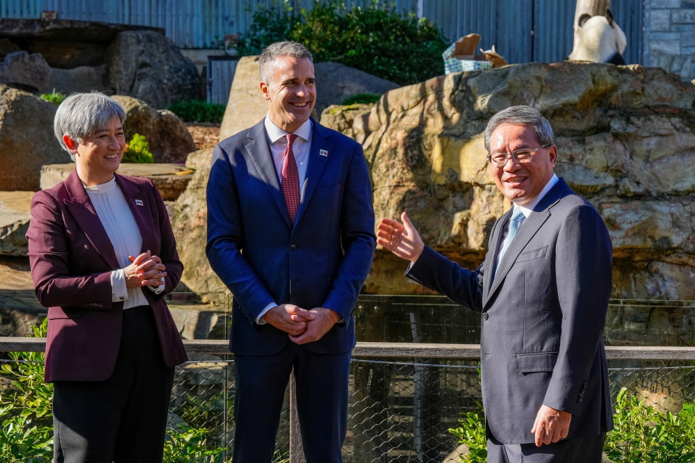 Australia's Foreign Minister Penny Wong, South Australian Premier Peter Malinauskas look towards China's Premier Li Qiang as he reacts in front of the Panda enclosure at Adelaide Zoo in Adelaide, Australia. — Reuters