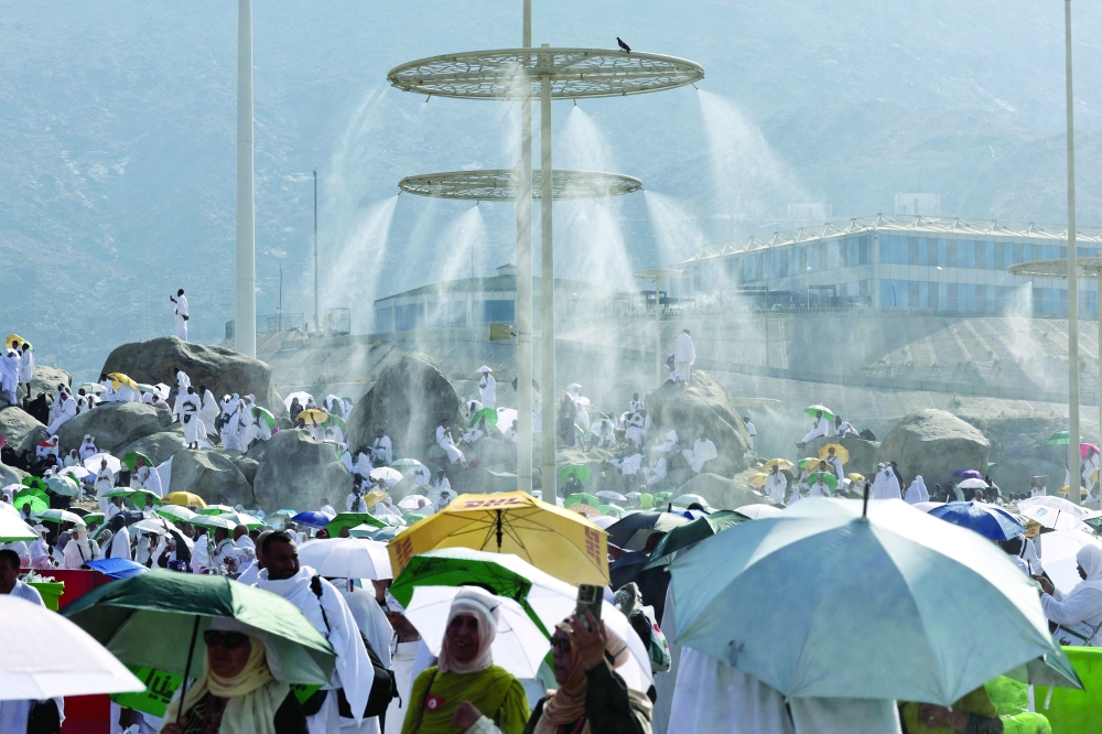 Mist dispensers refreshen Muslim pilgrims at the base of Mount Arafat. — AFP 