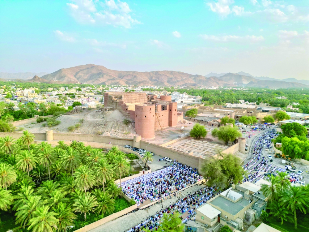 People perform Eid in Rustaq on Monday. 