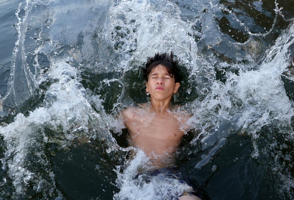 A boy swims in the Nile River amid a heatwave in El Qanater El Khayreya city, in Al Qalyubia Governorate, Egypt. — Reuters 