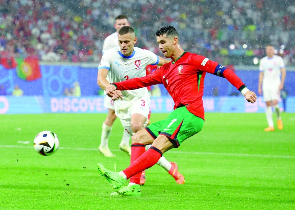Portugal's Cristiano Ronaldo in action with Czech Republic's Tomas Holes. REUTERS