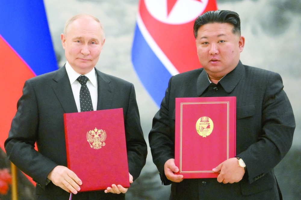 Vladimir Putin and Kim Jong Un attend a signing ceremony following their bilateral talks at Kumsusan state residence in Pyongyang. - AFP