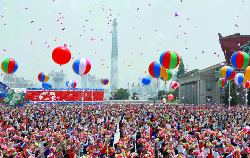 People release balloons in the air as Russia's President Vladimir Putin and North Korea's leader Kim Jong Un attend a welcoming ceremony at Kim Il Sung Square in Pyongyang. - AFP
