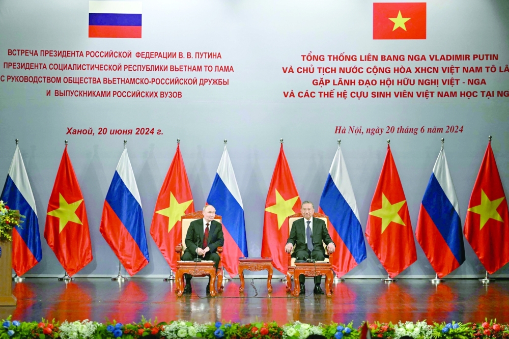 Russia's President Vladimir Putin (L) and Vietnam's President To Lam (R) take part in an event attended by the Vietnam Friendship Association, at the Hanoi Opera House in Hanoi. — AFP 