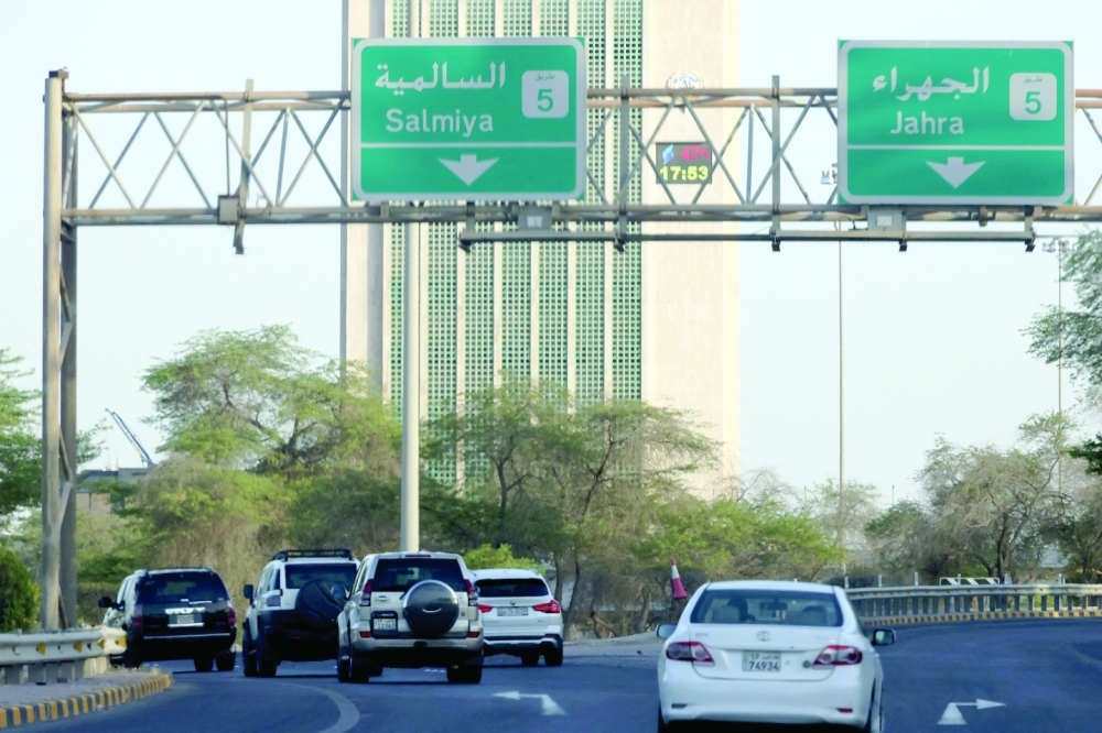 Cars drive past Kuwait's main governmental electricity control tower where a thermometer placed on the building reads 47 degrees Celsius, in Kuwait City. — AFP 
