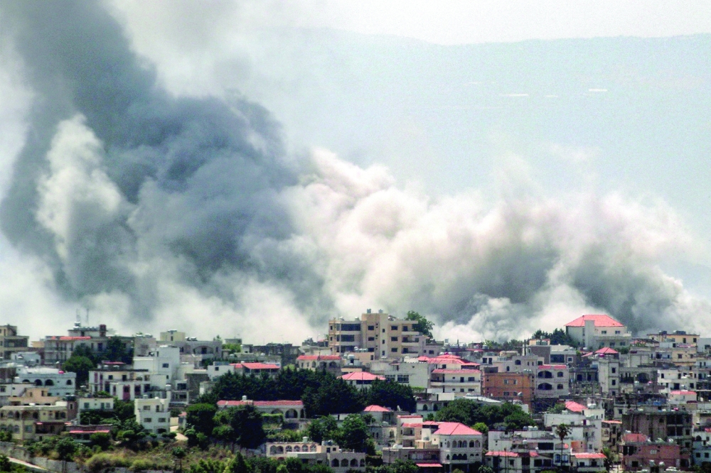 Smoke billows during Israeli bombardment on the village of Khiam in south Lebanon near the border. — AFP 