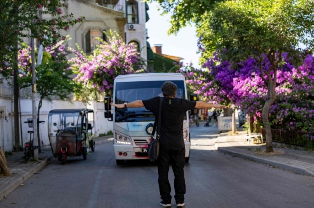 Lawyer and head of the Association of Friends of the Island Ibrahim Aycan is protesting to stop new minibuses on the island of Buyukada, in Istanbul 