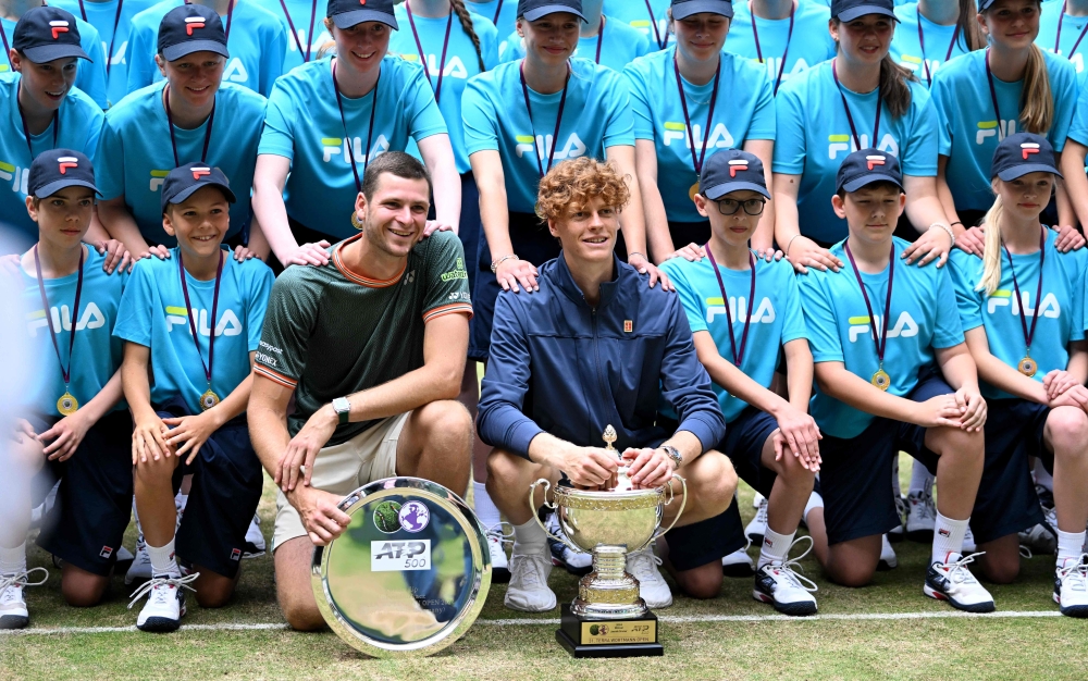 Sinner (C-R) and Hurkacz (C-L) pose with the ball girls and boys. — AFP

