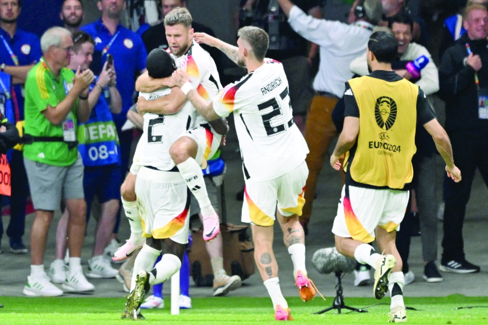 Niclas Fuellkrug celebrates scoring his team's first. — AFP