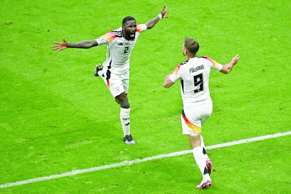 Germany's forward Fuellkrug and Ruediger after the Goal.— AFP