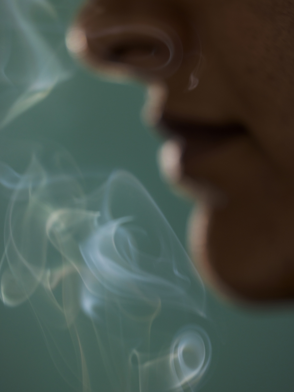 A photo illustration of someone smelling smoke. (Grant Harder/The New York Times)