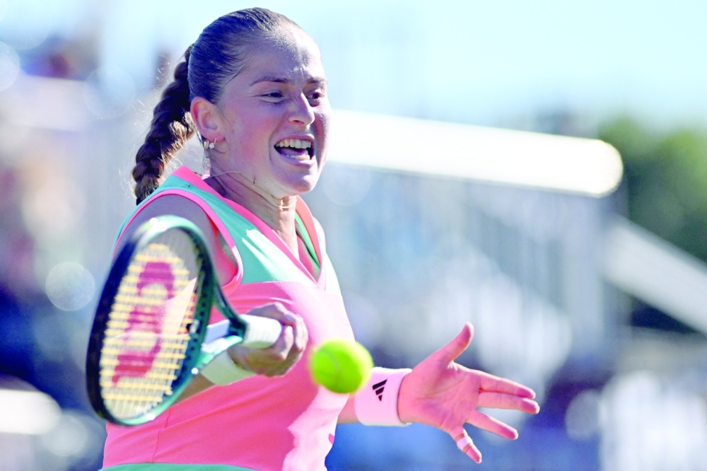 Latvia's Jelena Ostapenko hits a return to Greet Minnen. — AFP