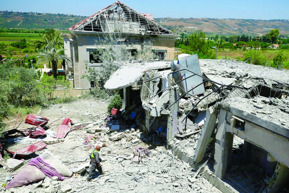A Lebanese civil defence member inspects the site of an Israeli airstrike on the southern village of Khiam near the Lebanese border with Israel. — AFP