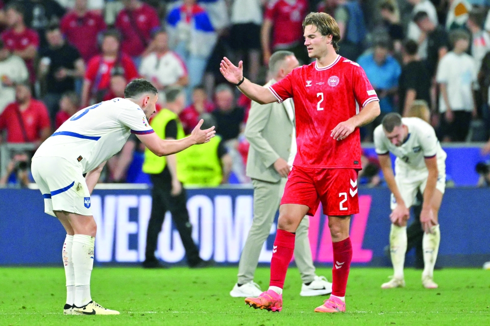 Milos Veljkovic  (L) reacts with Joachim Andersen after the draw. — AFP


