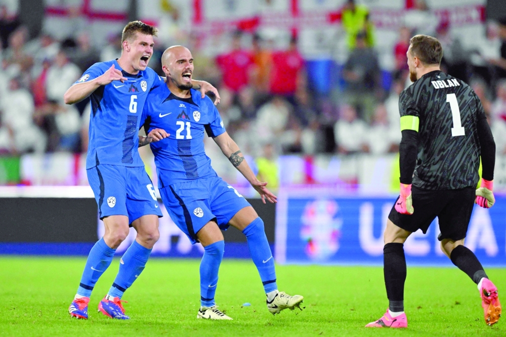 Slovenia's players celebrate qualifying. — AFP