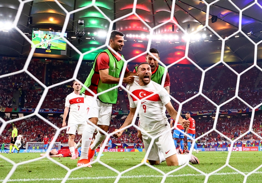Tosun celebrates scoring second goal with Celik. — REUTERS