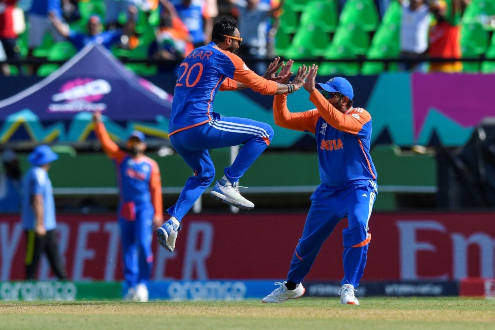 Kuldeep Yadav of India celebrates the dismissal of Harry Brook of England during the ICC men's Twenty20 World Cup 2024 semi-final cricket match 