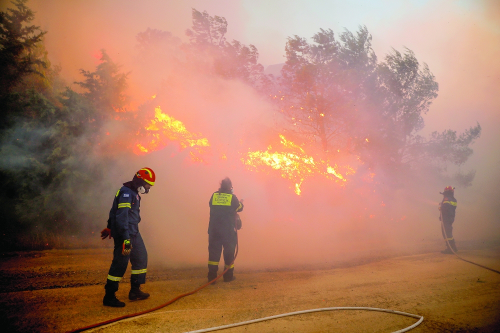 Wildfire fanned by strong wind rages near Athens