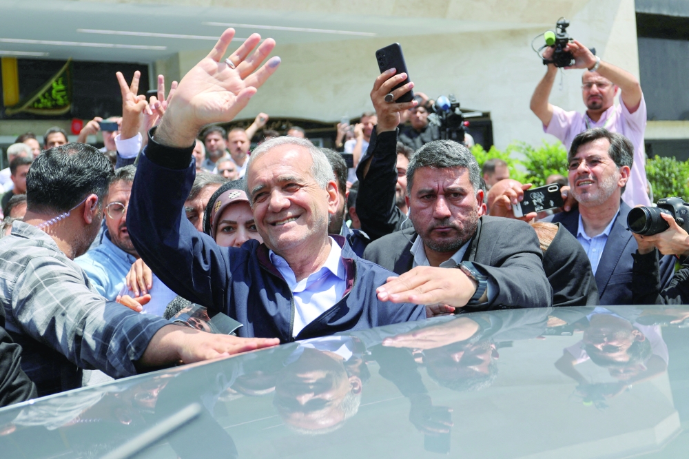 Presidential candidate Masoud Pezeshkian waves to supporters on the day of the presidential election to choose a successor to Ebrahim Raisi following his death in a helicopter crash. - Reuters