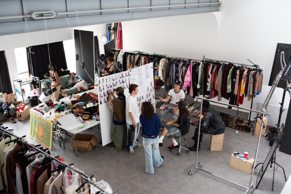 Colm Dillane, a.k.a. KidSuper, center and his team at work in a studio, preparing for his fashion show at Trianon in Paris, June 21, 2024.  (Sam Hellmann/The New York Times)