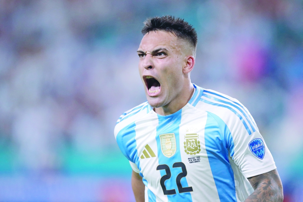 Lautaro Martinez celebrates scoring his team's first goal during the Conmebol 2024 Copa America tournament group A football match between Argentina and Peru at Hard Rock Stadium in Miami, Florida on June 29, 2024. 