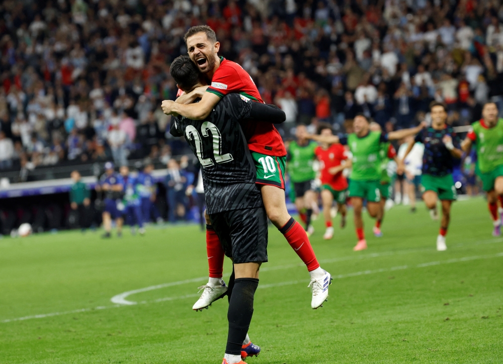 Portugal's Bernardo Silva celebrates with Diogo Costa after scoring the winning penalty. — REUTERS

