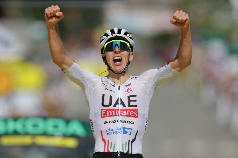 UAE Team Emirates team's Slovenian rider Tadej Pogacar cycles to the finish line to win the 4th stage of the 111th edition of the Tour de France cycling race, 140 km between Pinerolo in Italy, and Valloire in France, on July 2, 2024. (Photo by Thomas SAMSON / AFP)