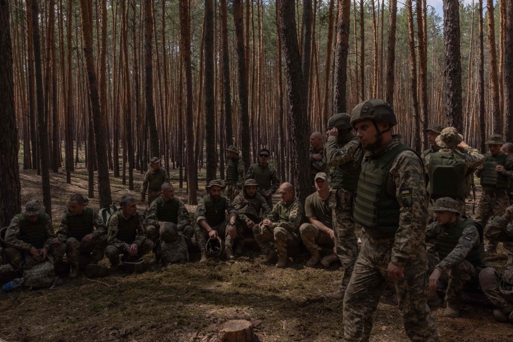 TOPSHOT - Ukrainian convicts who joined the 92nd Assault Brigade of Ukraine's army attend a training session in an undisclosed area in the Kharkiv region, on June 28, 2024, amid the Russian invasion of Ukraine. (Photo by Roman PILIPEY / AFP)