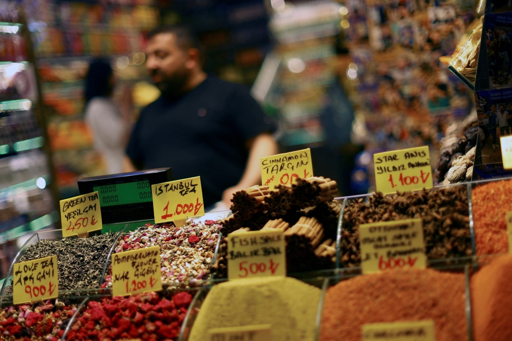 In Istanbul, a pictured spice market with a salesman showcasing various spices, each marked with its distinctive price tag. — Reuters