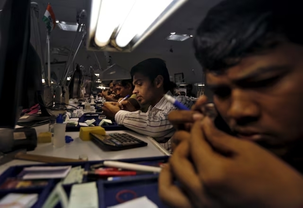 Craftsmen work at the polishing department of a diamond processing unit at Surat in Gujarat, India. — Reuters